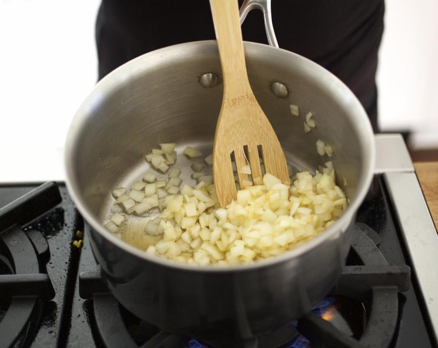 step 7 Pour 1/2 cup of the vegetable broth into a medium saucepot over medium-high heat and add the onions. Sauté until translucent, about 5 minutes.