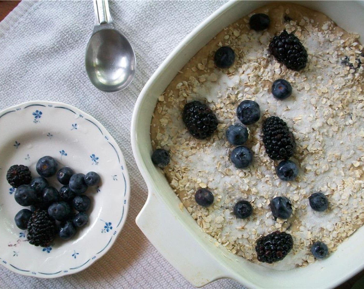 step 5 Spread the batter in dish and sprinkle with some more sugar and oats. Scatter remaining berries evenly over top.