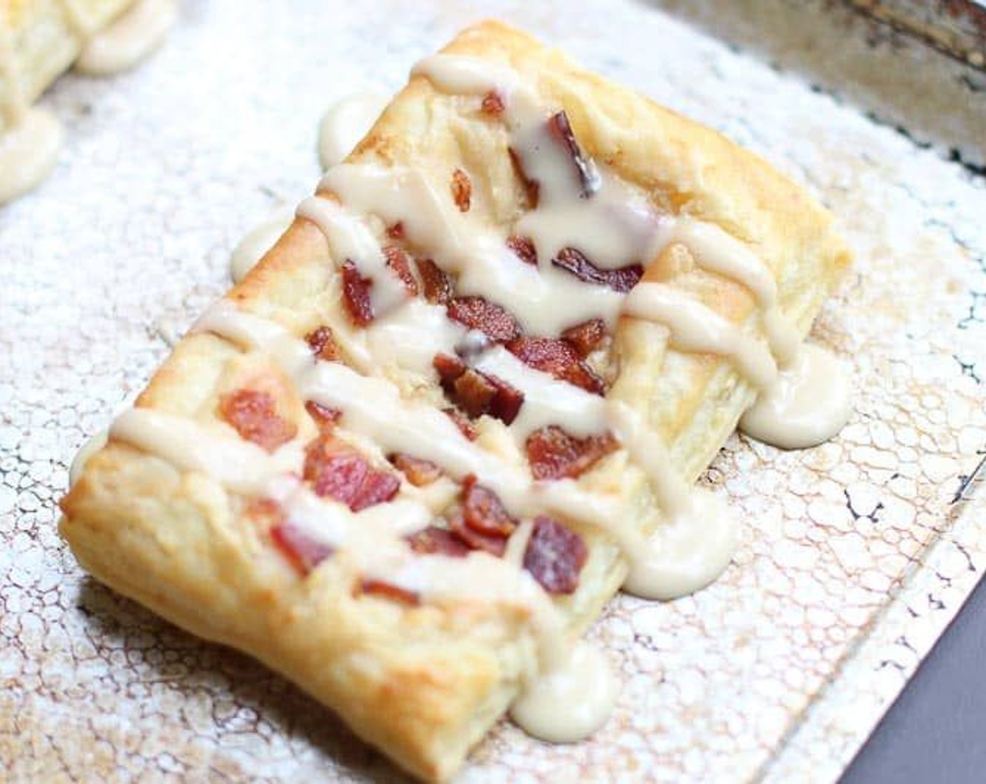 step 10 Transfer the icing to a small Zip-loc bag, seal, and cut off the tiniest tip of the bottom corner. Drizzle over the cooled danishes.