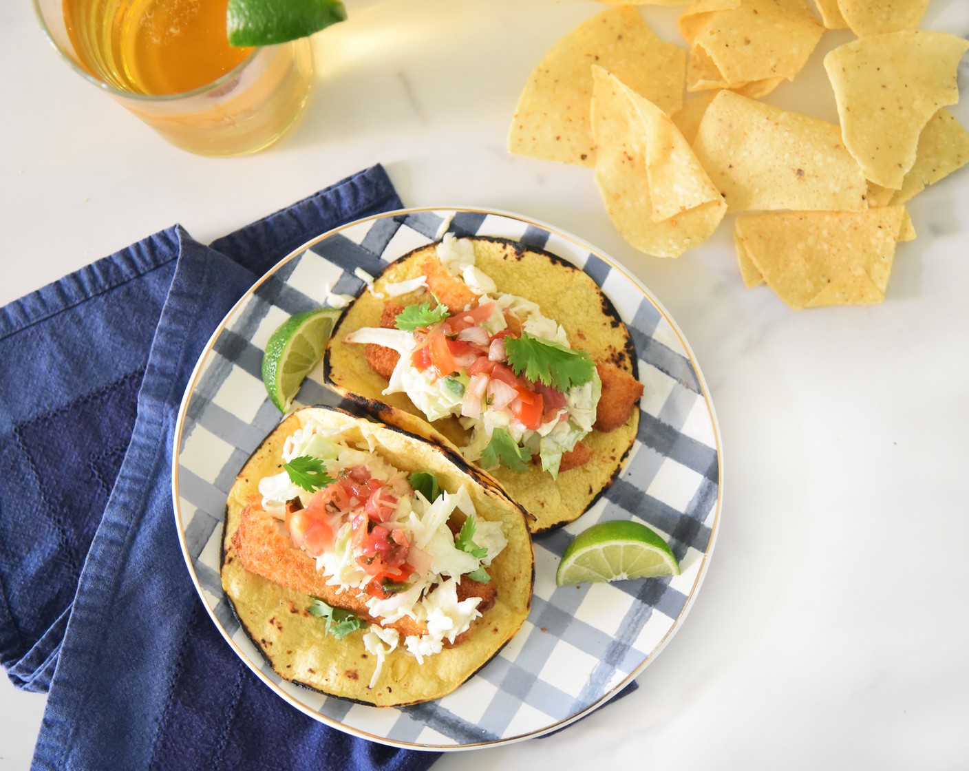 step 5 To serve, top a tortilla with two fish sticks. Top the fish sticks with desired amount of coleslaw. Optionally, you can add Pico de Gallo (to taste), Fresh Cilantro Leaves (to taste), and a squeeze of Limes (to taste) to each taco. Serve warm.