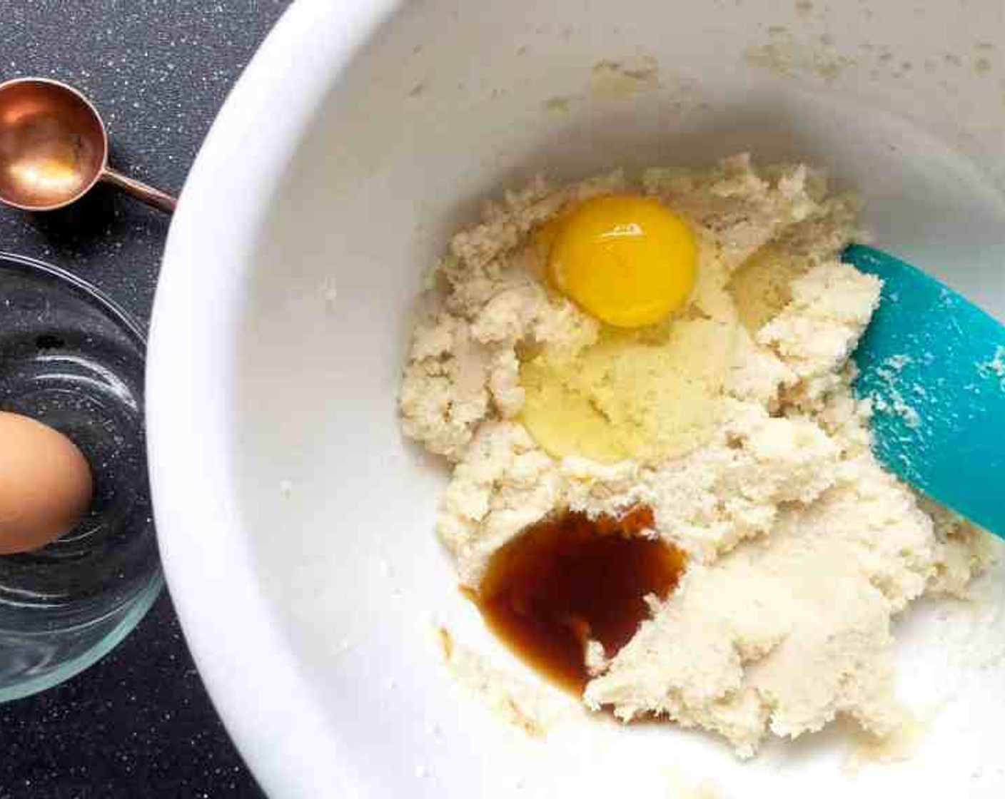 step 3 Scrape down the sides of the bowl with a rubber spatula. At low speed, add Pure Vanilla Extract (1 Tbsp) then the Farmhouse Eggs® Large Brown Egg (1). Scrape down the bowl again.