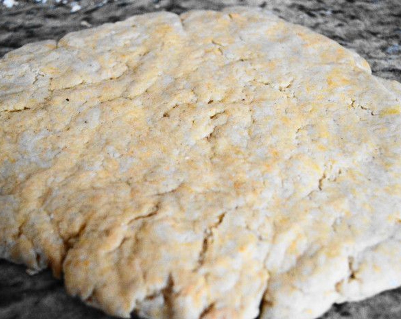 step 7 Bring it together into a ball and turn it out onto a clean, lightly floured surface. Knead the dough for just 3 or 4 turns to make it soft and uniform. Press it down and pat it out gently to be a disc about 2.5-cm (1-inch) thick.