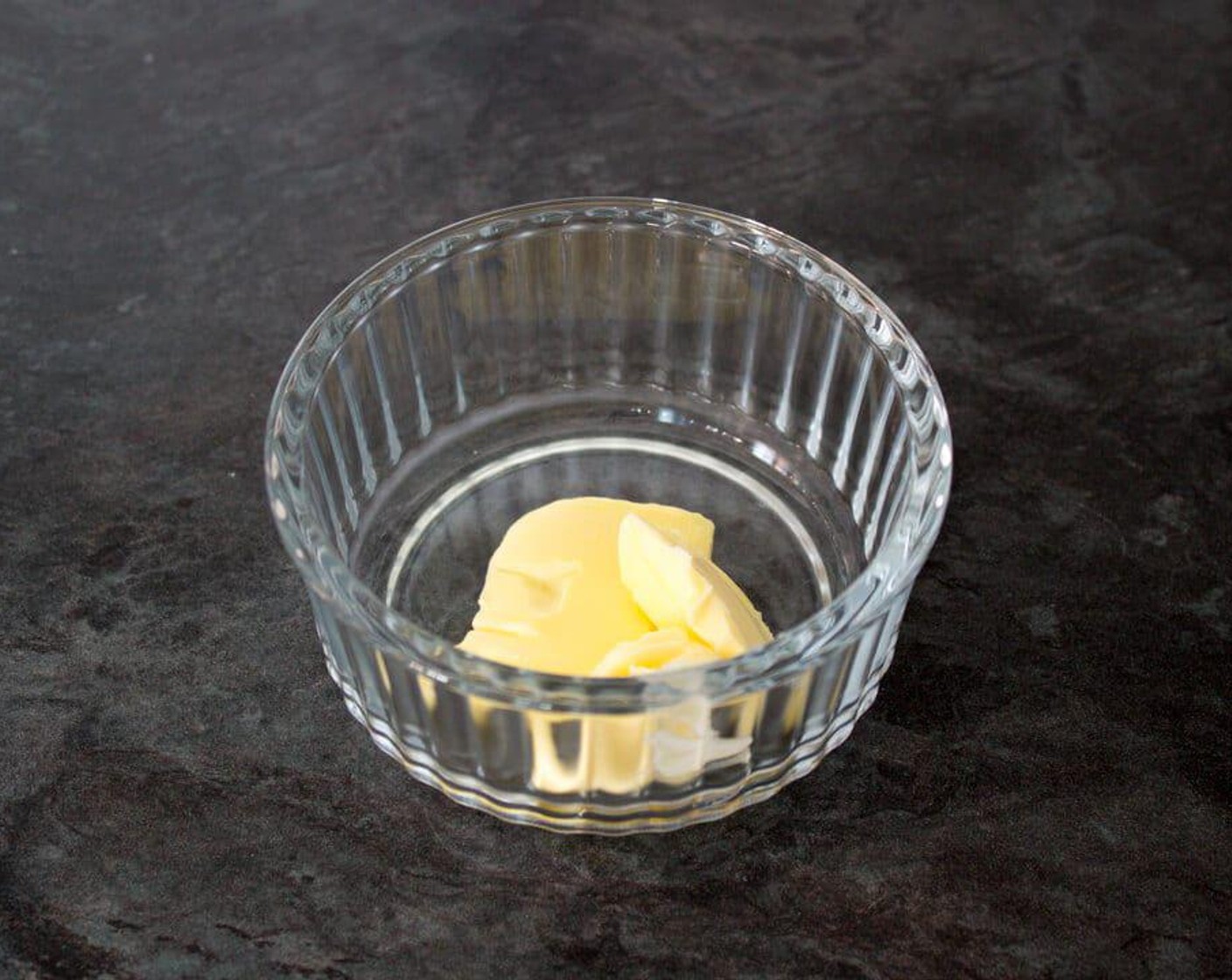 step 2 Add the Butter (1/2 Tbsp) the ramekin, then pop it in the preheating oven to allow it to melt.