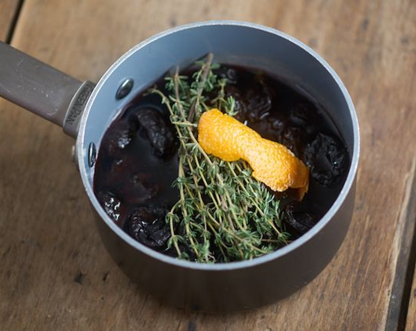 step 1 Place the Prunes (1 3/4 cups) in a small saucepan with Fresh Thyme (6 sprigs), peel of the Orange (1), and Water (1/2 cup). Fill with Red Wine (1/2 cup) until fruit is just covered, depending on the size of your pan.