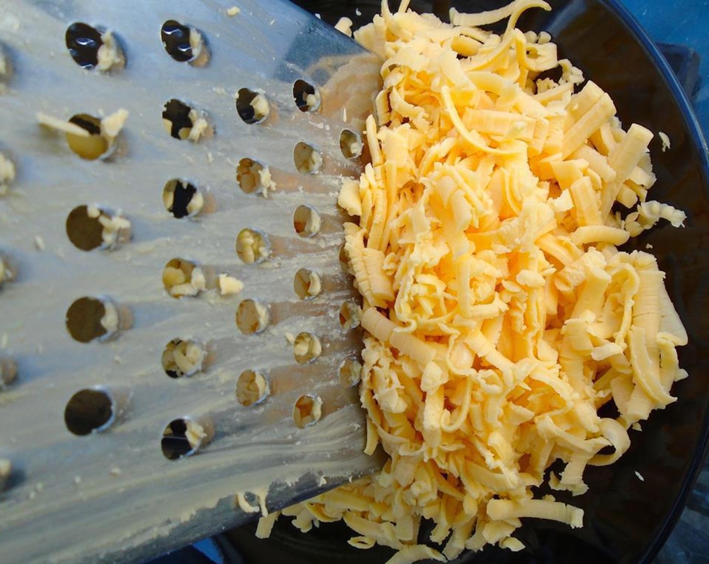 step 2 Grate Cheddar Cheese (1 cup) and Parmigiano-Reggiano (1 cup) and set aside.