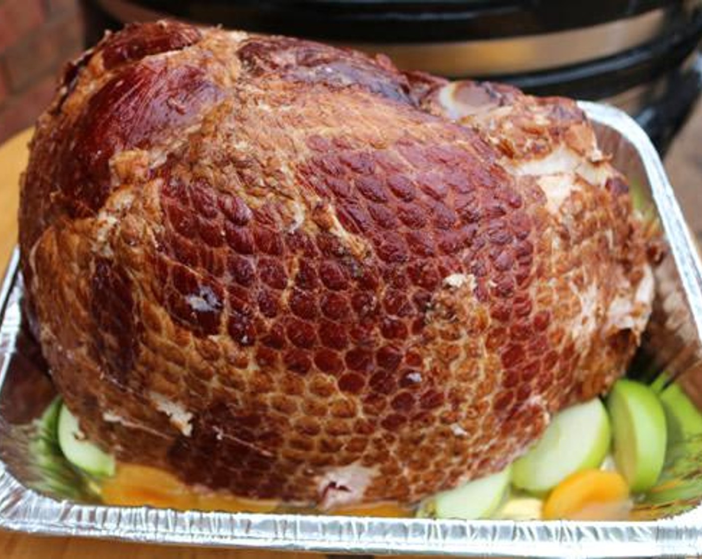 step 2 Remove the Bone-In Ham (1) from the packaging and use a box cutter or knife to score the ham in both directions. Place the scored ham on top of the apples and apricots meat side down.