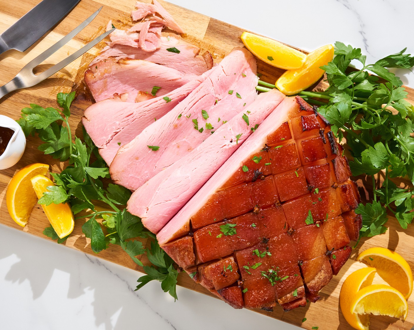 step 7 Transfer to a serving dish. Optionally, garnish with Oranges (2), Fresh Parsley (1/2 cup) on the side of the dish. Slice the ham and serve it with your favorite side dishes!