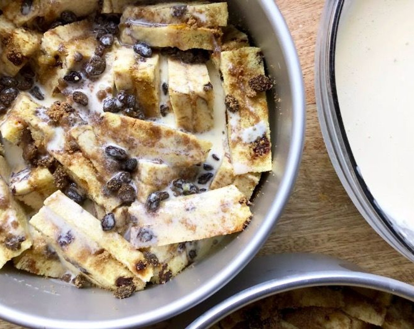 step 7 In a large bowl, whisk together the Heavy Cream (2 cups), Sweetened Condensed Milk (1 can), and Farmhouse Eggs® Large Brown Eggs (2). Pour the mixture evenly over the bread. Press bread down to absorb the cream mixture.