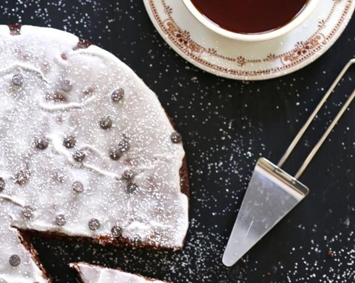 step 5 Remove from oven and cool completely. Mix the Powdered Confectioners Sugar (1 1/2 cups) and Milk (2 1/2 Tbsp) in a bowl. Pour the icing evenly over the cake. Garnish with mini chocolate chips and dust with confectioners sugar.