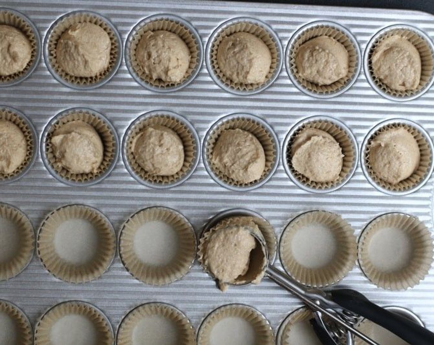 step 6 Using a 1 1/2 tablespoon scoop, place batter in muffin liners. This is the easiest way to ensure that each of your mini-muffins will be the same size and bake evenly.