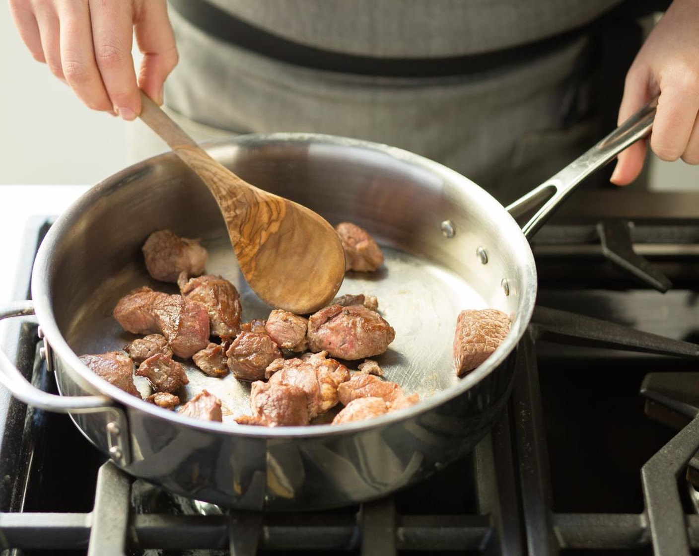 step 7 Heat a 3-inch deep sauté pan over high heat and add Olive Oil (2 Tbsp). When the oil is hot carefully add the lamb and cook for 3 minutes on each side until browned. Transfer to a plate.