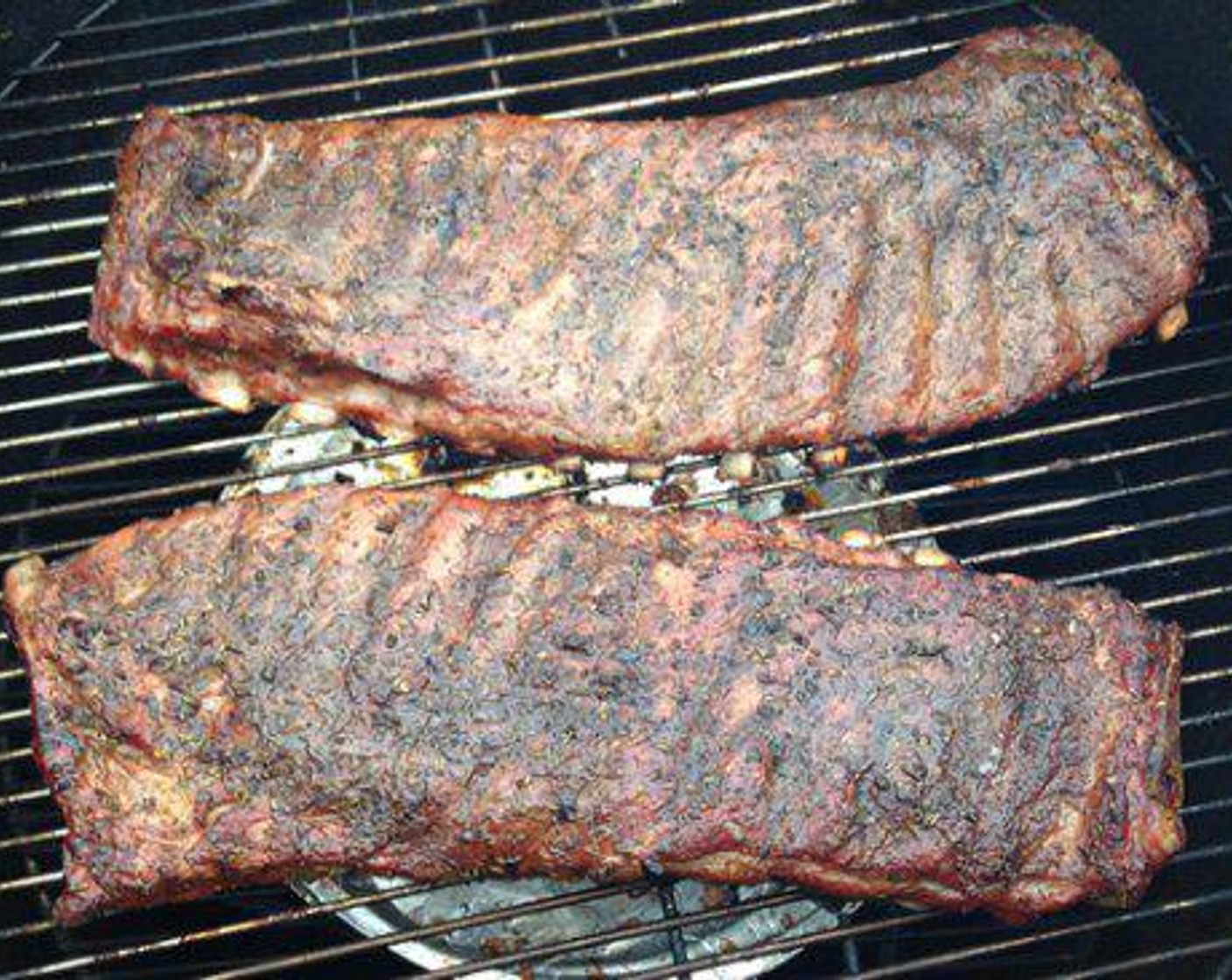 step 6 Once the smoker is ready the Jerk Style Spare Ribs can be placed on the racks. The first 2 hours of the cooking process is all about the smoke. Spritz the ribs with pineapple juice every 30 minutes. After 1 hour flip the ribs meat side down, so both sides get some color. I want to see them a little browned on both sides before wrapping.