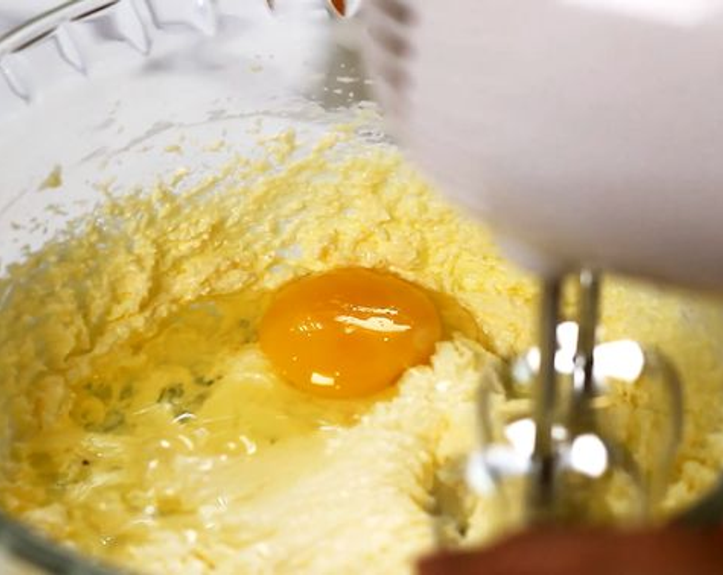 step 3 Crack in an Egg (1), beat well. Then drizzle in Vanilla Extract (1 tsp) until smooth.