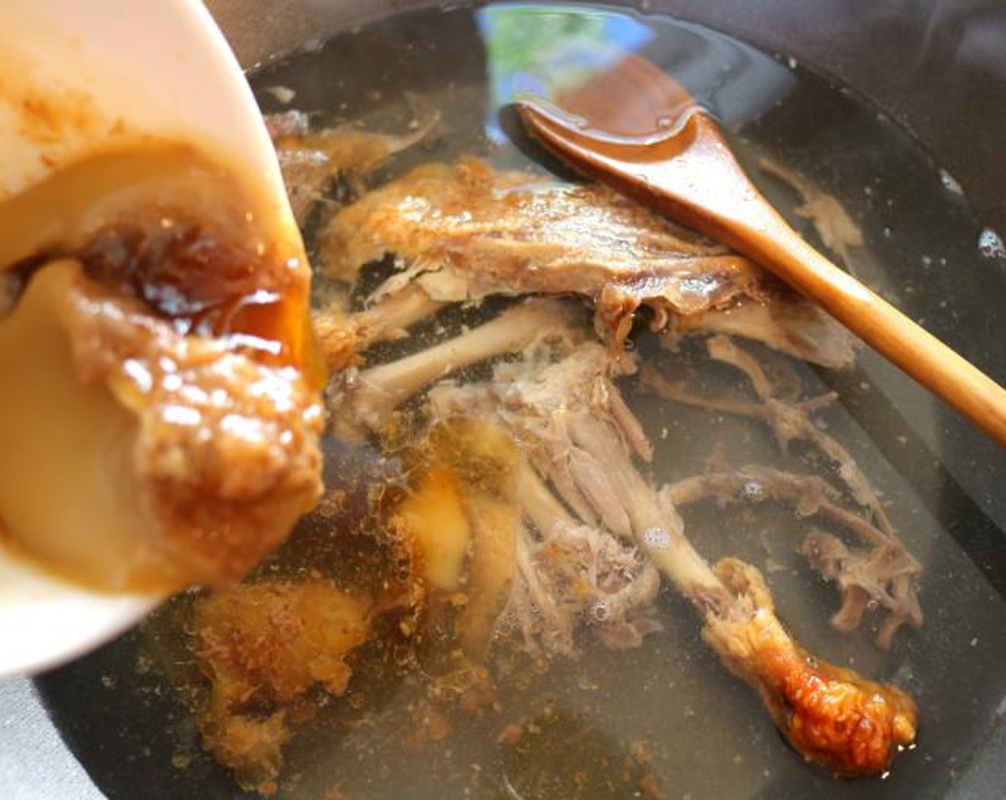 step 6 Add the duck bones, the skin and scraps to Chicken Stock (4 cups), add all the juices and 2 tablespoons of duck fat that have collected when roasting the duck. Simmer for 30 minutes or until there is 1/2 quart stock left.