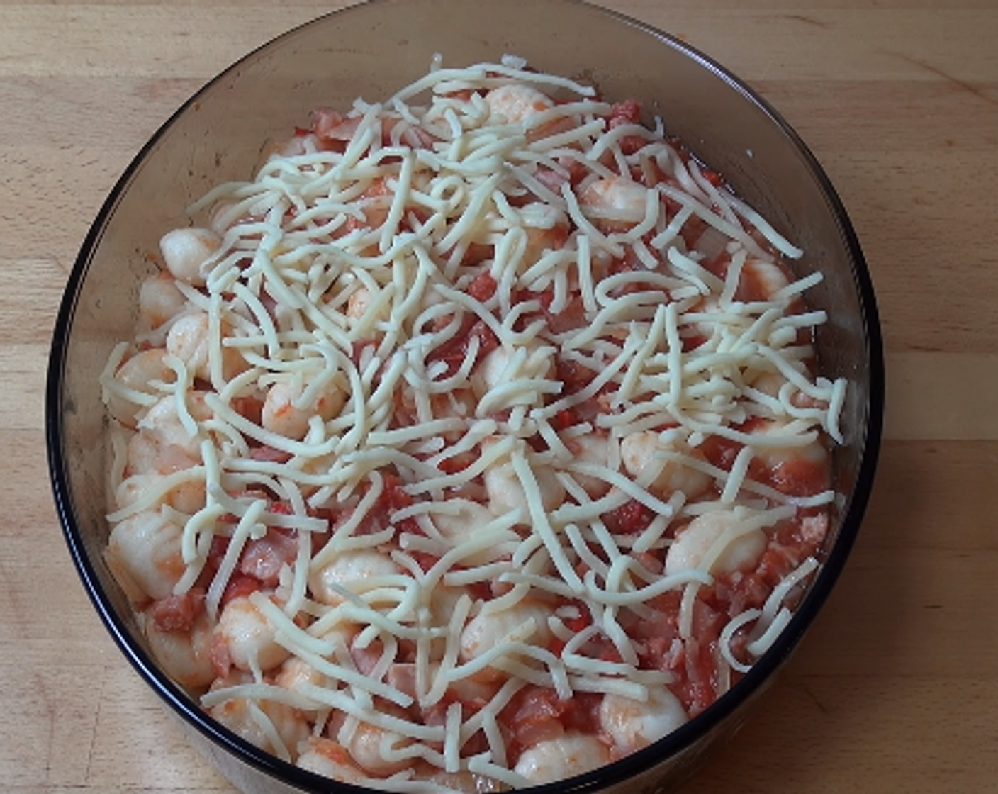 step 4 Season with Salt (to taste) and Ground Black Pepper (to taste) and add in the gnocchi. Transfer to a casserole dish and sprinkle with some Cheese (1 cup). Cook at 200 degrees C (400 degrees F) for 10 to 15 minutes or until the cheese is melted and bubbly.