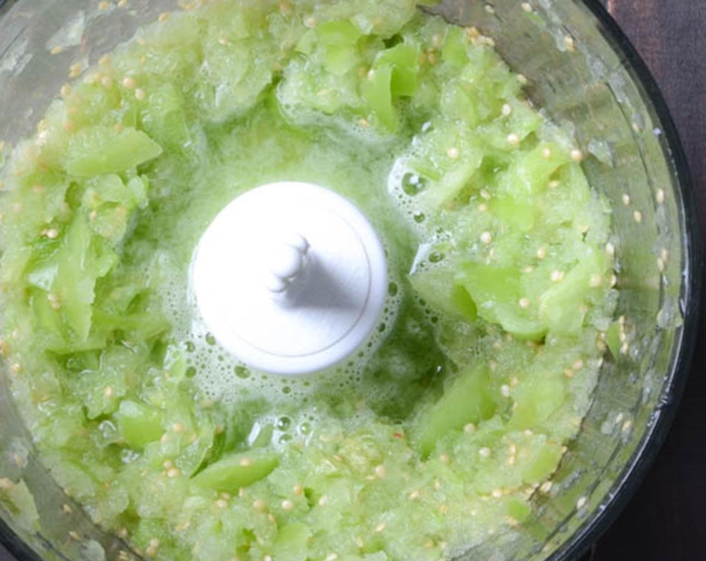 step 2 Add the Tomatillos (8 oz) to a small food processor and pulse several times until finely chopped. Set aside.