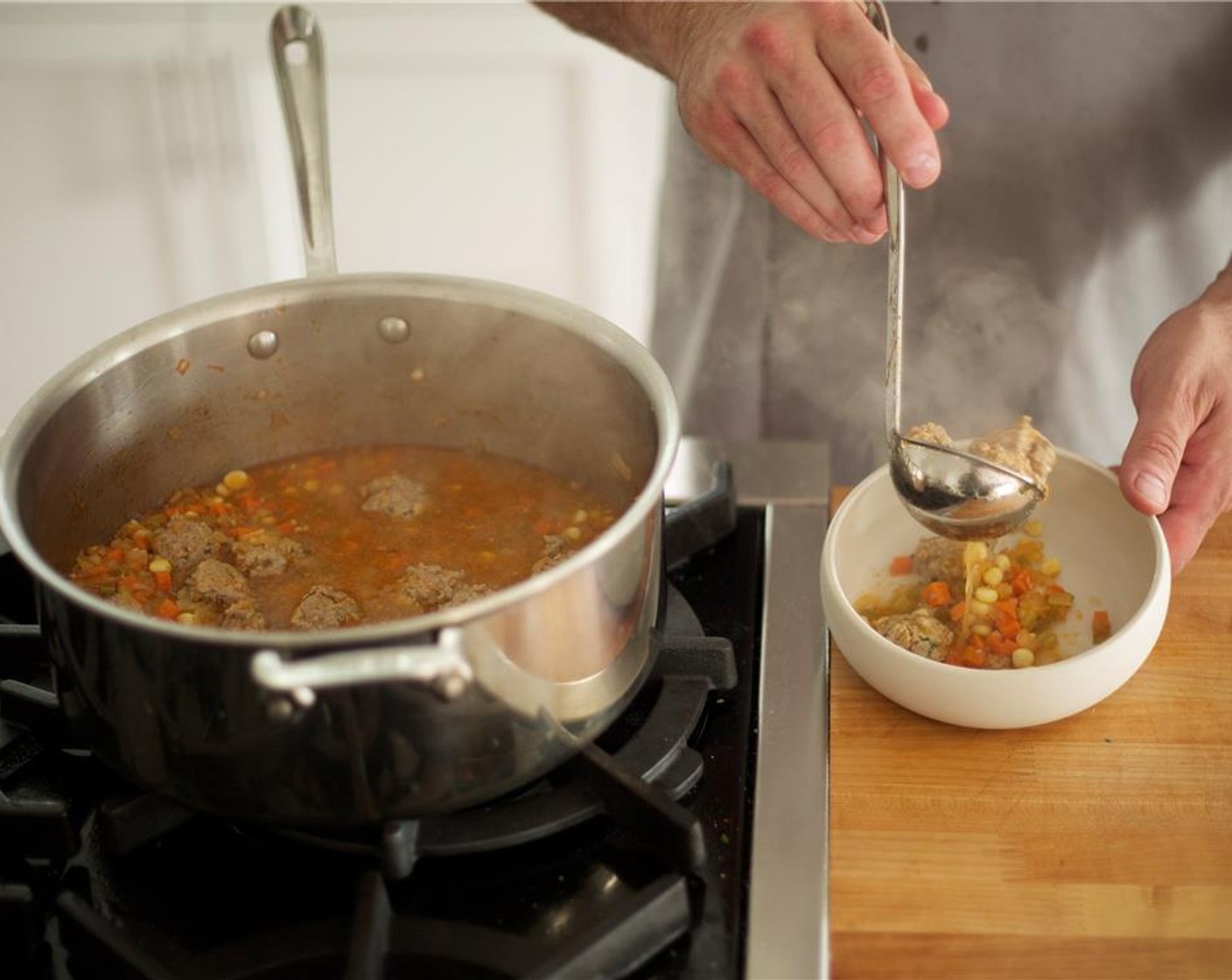 step 15 Remove bay leaf and ladle soup into two bowls with equal portions. Split serrano into each bowl to increase spice level if preferred. Garnish with the remainder of the mint over the top of soup. Carefully place crispy tortilla strips upward in the center of the soup.