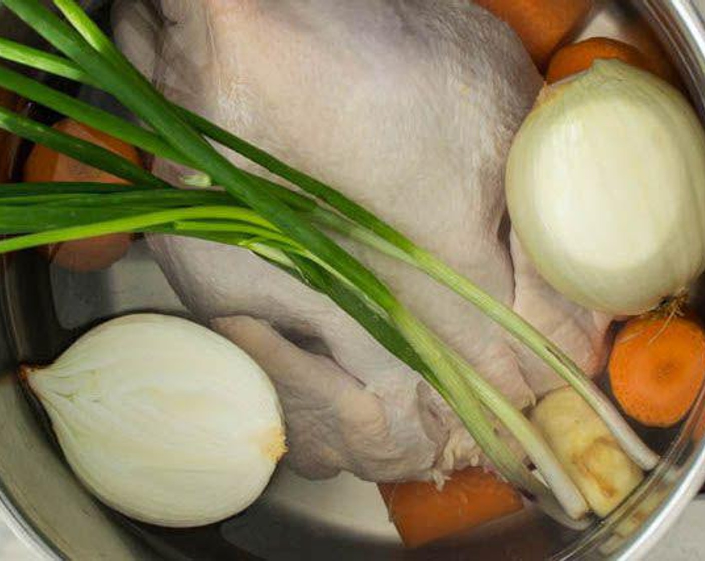 step 2 Add the Carrots (2), Onion (1), Scallions (3 stalks) and Fresh Ginger (1 in) to the pot.