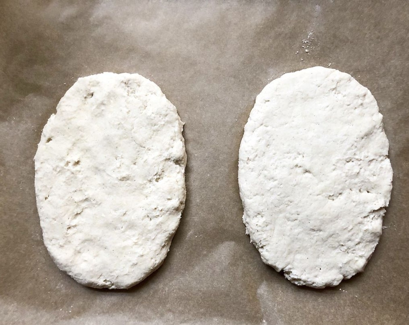 step 7 Dust the surface of the dough and the parchment paper with rice flour or any gluten-free all-purpose flour. Pull off a 1-pound (grapefruit-size) piece. Quickly pat it into a ball on the prepared parchment. Smooth and flatten into a disk by gently pressing with your fingers, until you reach a thickness of 1/2-inch.