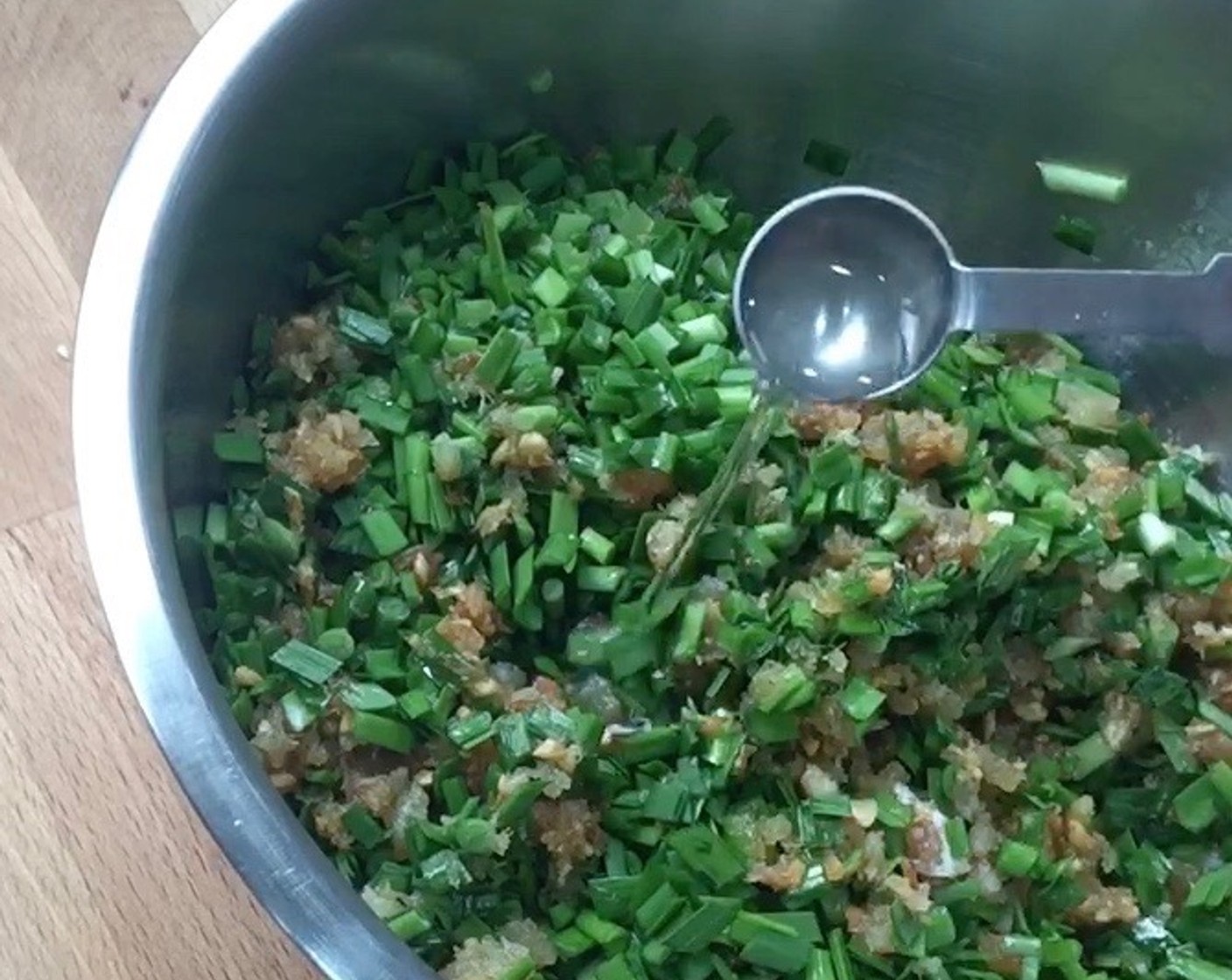 step 7 Then add in Alkaline Water (1 tsp). This will help keep the chives green. Be sure they are well mixed. Set aside while we make the skin dough.