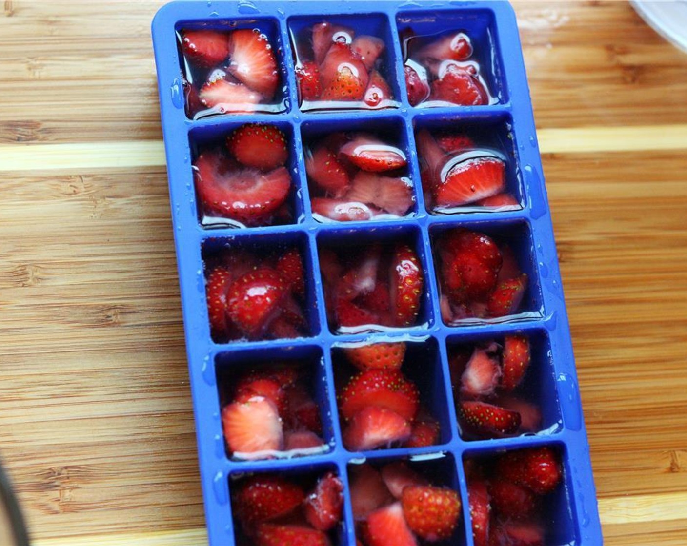 step 3 Spoon berries into an ice cube tray, evenly distributing them until used up, filling each cavity about 3/4 full. Add Water (to taste) to tray until each cavity is full. Freeze overnight.