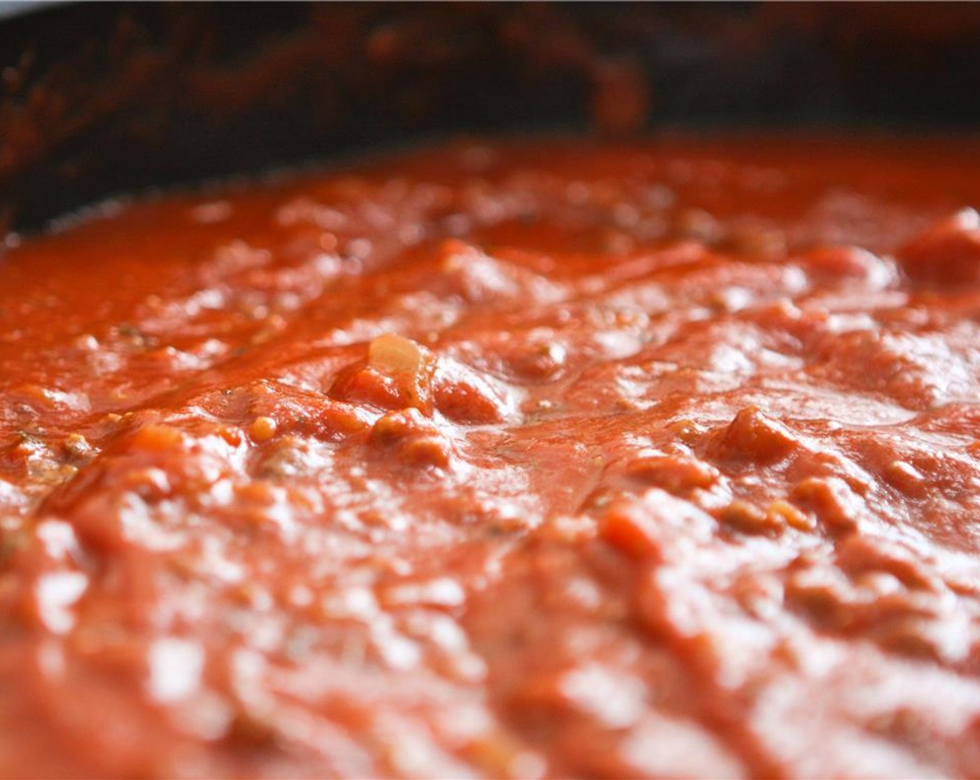 step 4 Add Pasta Sauce (2 jars) and simmer for 15 minutes. During this time, preheat the oven to 350 degrees F (180 degrees C) and coat a 9x13-inch baking dish with cooking spray.