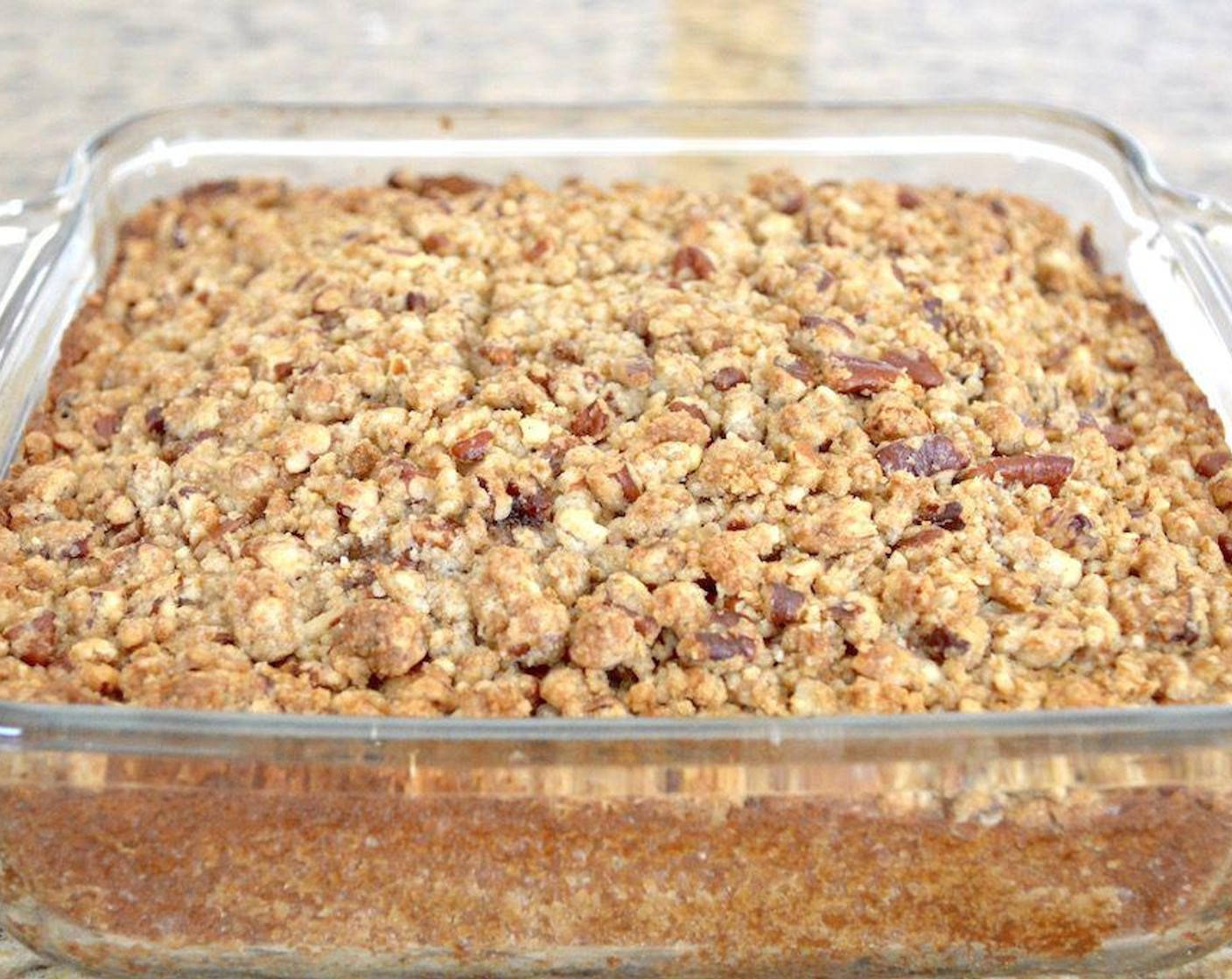 step 5 Pour that batter into the prepared pan and make sure it is even. Then evenly sprinkle the crumb mixture on top in a layer. Bake the cake for about 45 minutes, until the outside is golden and the interior is baked through. The middle will puff up a lot and that is normal.