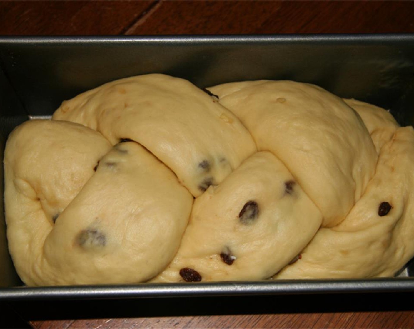 step 10 Starting there, braid the strips of dough together and fold both ends under. Place the braid into a greased 9×5 inch loaf pan. Cover loosely and set aside for 40 minutes.