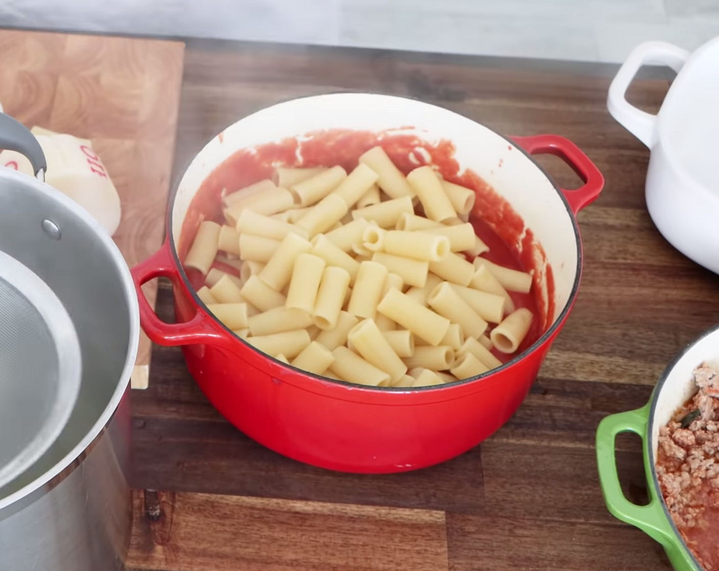 step 16 Once you have strained the pasta for your baked rigatoni, put it into the pot filled with sauce – not a mixing bowl! Mix the pasta and the sauce using a wooden spoon so each piece of pasta is completely covered.