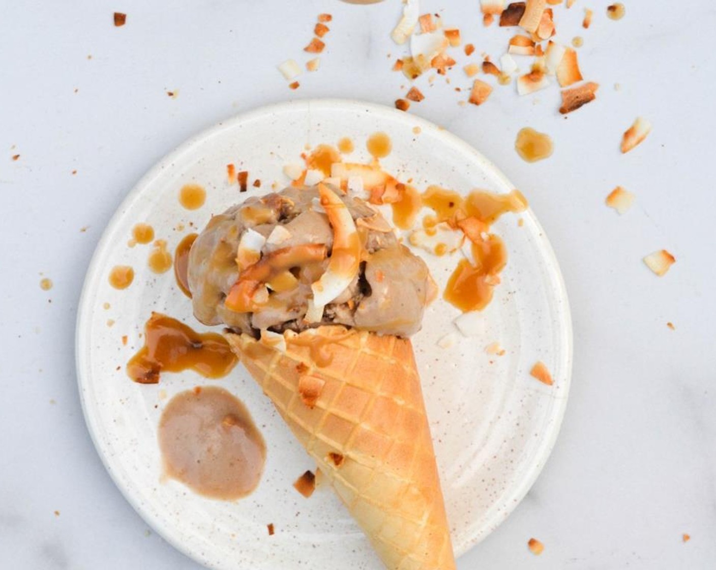 step 4 To make the optional salted caramel sauce, melt Brown Sugar (4 Tbsp) into the Fresh Cream (1 cup), stirring constantly. Reduce until thickened and add Smoked Sea Salt Flakes (1 pinch). Allow to cool slightly before drizzling over the ice cream.
