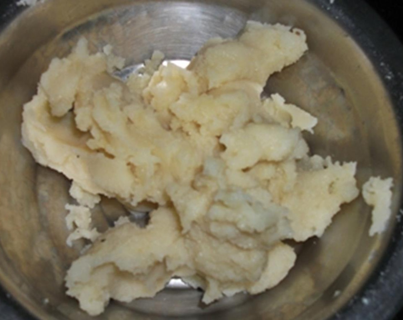 step 2 Use a potato ricer or a fork to mash the potatoes & pass them through a sieve.