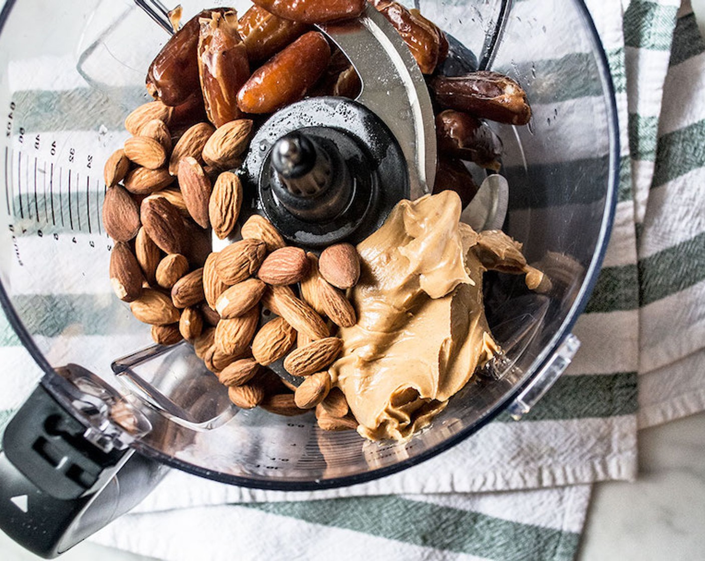 step 5 Meanwhile, add Medjool Dates (1 cup), Raw Almonds (3/4 cup), and Nut Butter (3/4 cup) to a bowl of a food processor. Blend on high for 15-20 seconds.