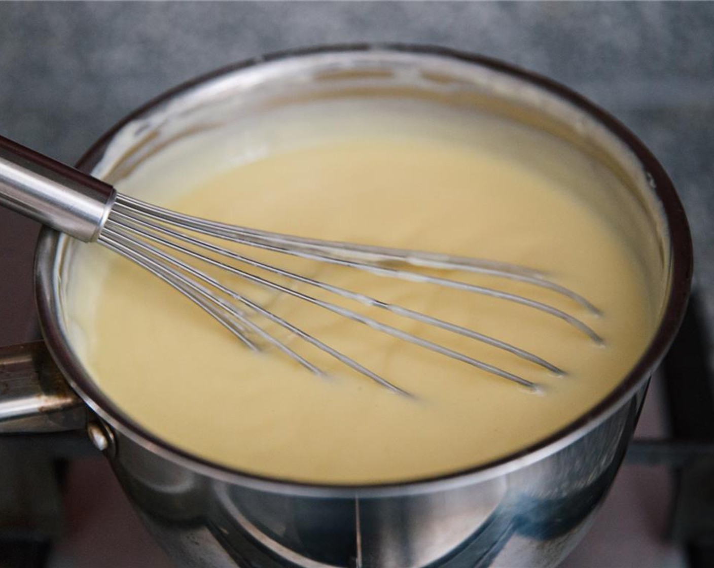 step 6 Continue to whisk, making sure to cook slowly until the custard mixture has thickened. This should take about 10 minutes. Remove from the heat.