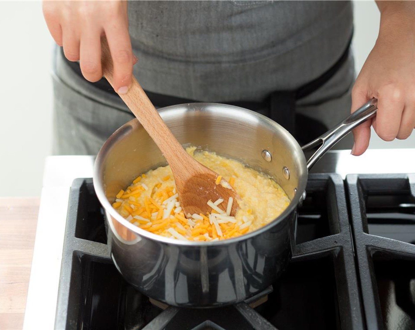 step 11 When the grits are finished cooking, add the Cheddar Cheese (2/3 cup) and the remaining Butter (2 Tbsp) and stir to combine. Remove from heat and hold for plating.