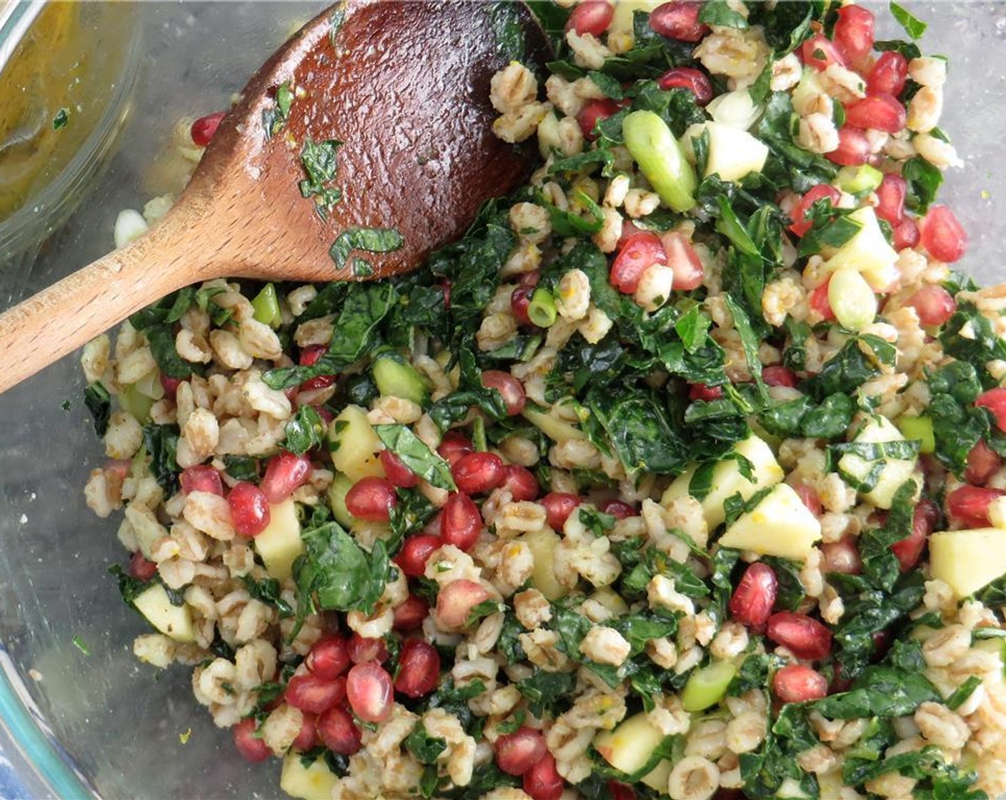 step 4 In a large bowl, combine the Pomegranate Seeds (1/2 cup), apple, Tuscan Kale (2 cups), and farro. Toss to combine. Add 3 tablespoons of the dressing to the salad and toss. Add more dressing if it seems too dry.