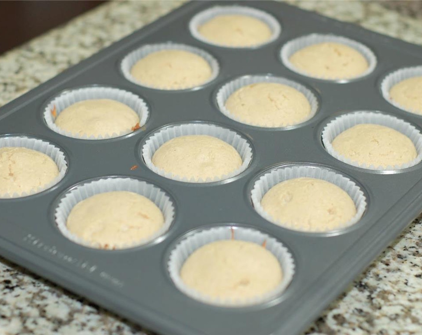 step 5 Place 16 cupcake liners into muffin pans and equally divide batter into each cupcake liner, about 1/2 way full.