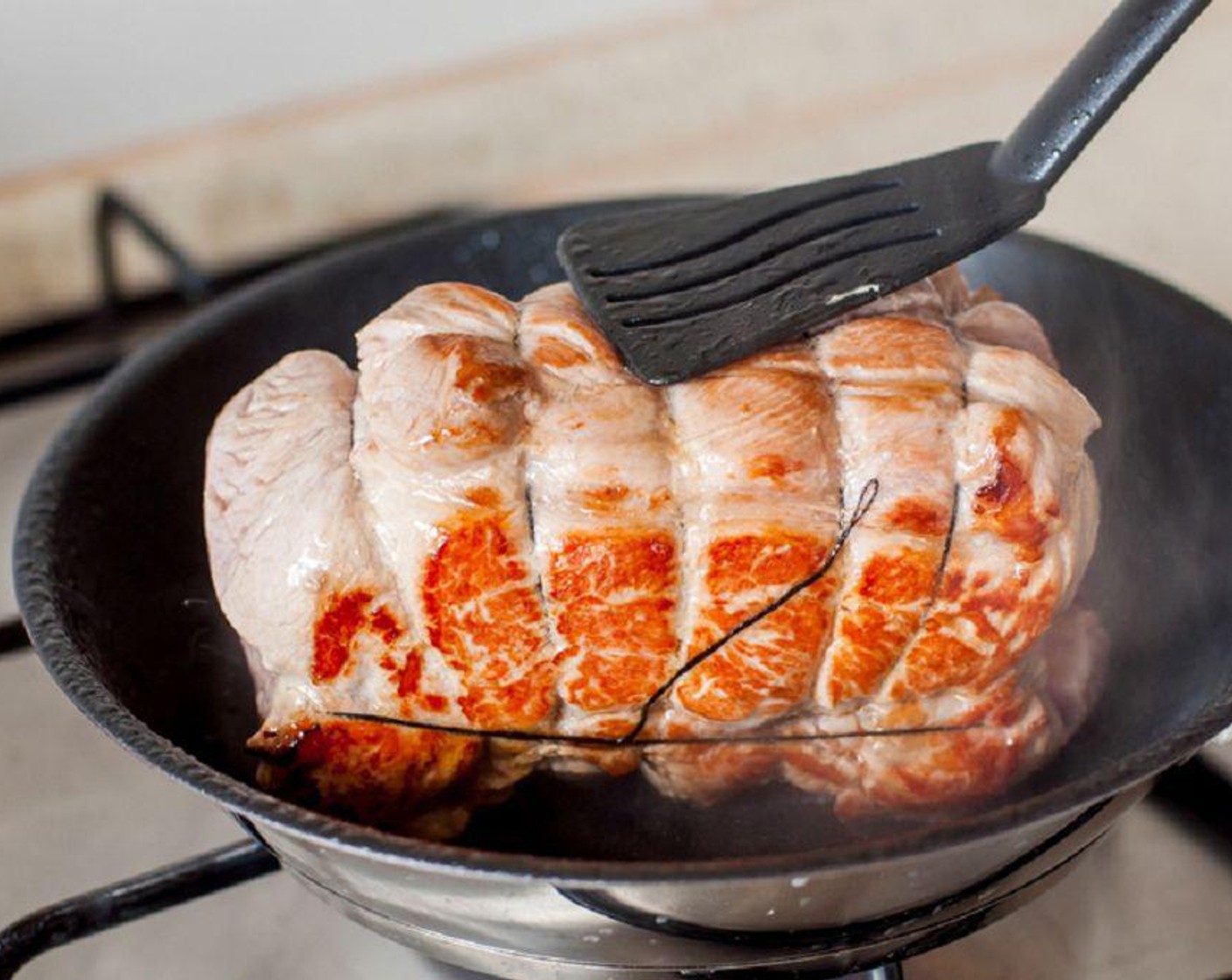 step 2 In a large frying pan placed over medium high heat, put a tablespoon of the Olive Oil (2 Tbsp). Add the pork. Cook for 5 minutes or until the skin has turned brown. Transfer this to a 5.5 liter slow cooker.