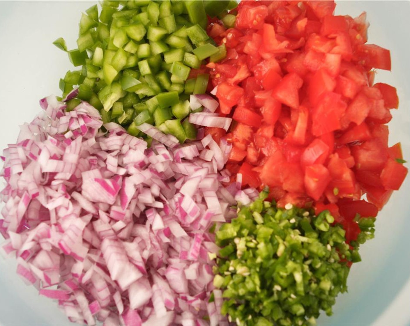 step 6 In a large bowl, combine the bell pepper, tomatoes, red onion, and jalapenos.