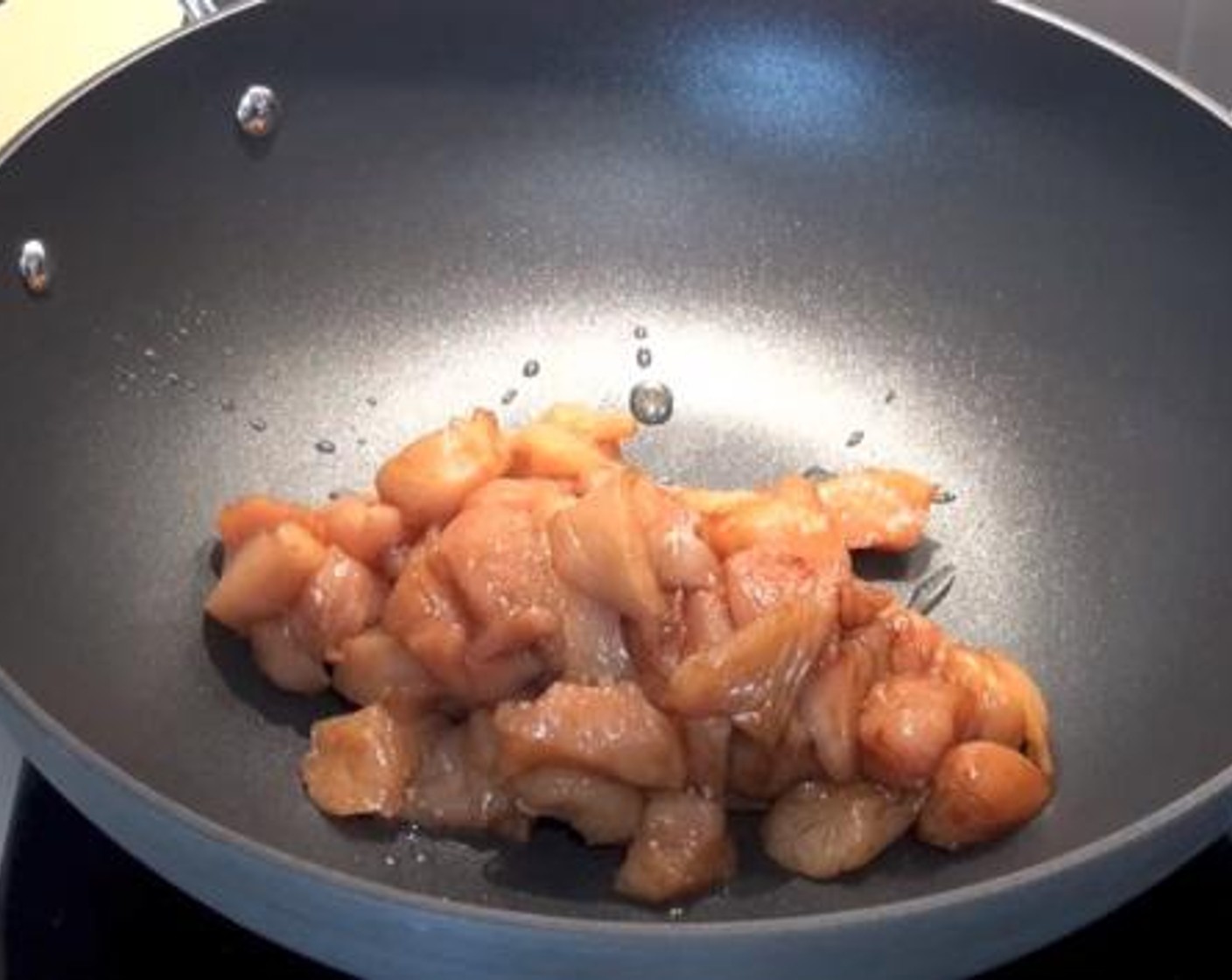 step 1 Into a wok greased with some Sesame Oil (1 Tbsp), cook the Chicken Breasts (1.1 lb). Set aside for a while.