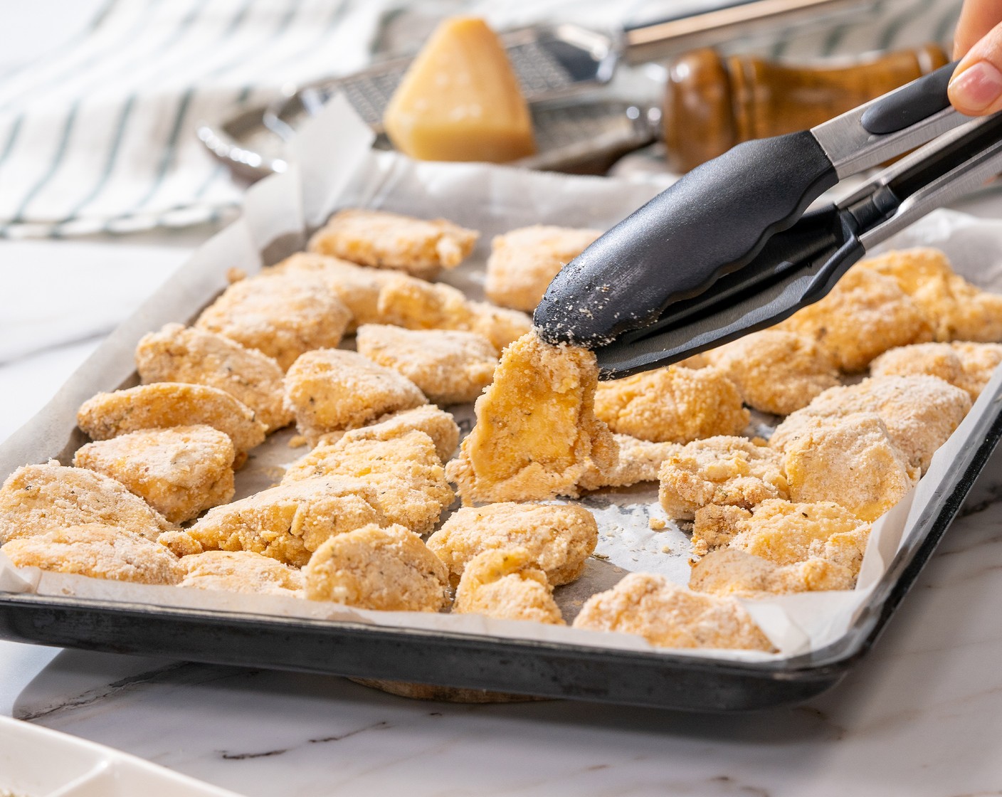 step 8 Remove from the oven and flip the nuggets, then spray with Nonstick Cooking Spray (to taste) on top. Bake for 5 minutes or until golden brown and crispy.