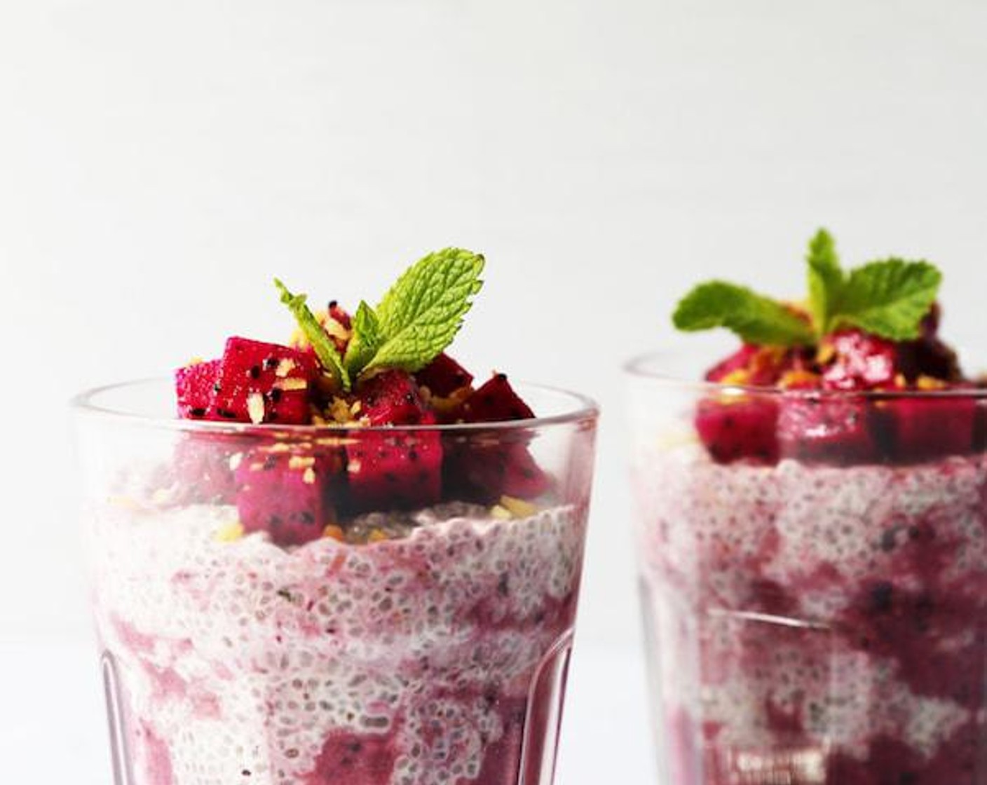 step 5 Decorate with extra chopped dragon fruit, coconut chips, a drizzle of honey and mint.
Serve immediately. Enjoy!