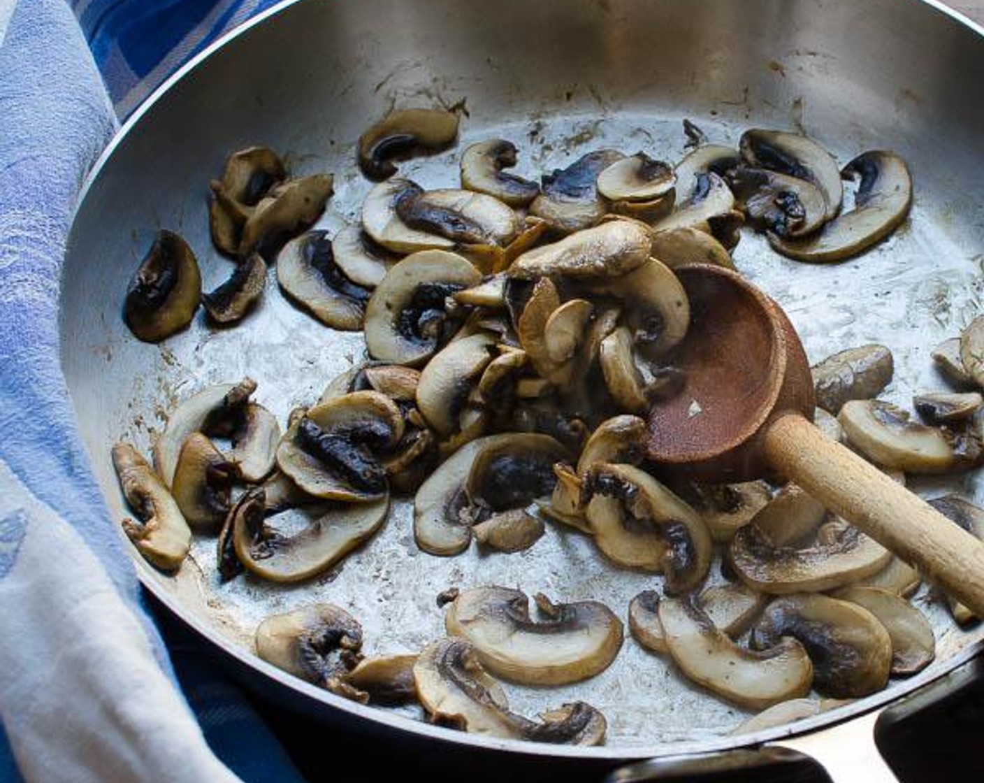 step 2 In a large saute pan over medium high heat add the Olive Oil (1 Tbsp) and Mushrooms (4 1/2 cups). Saute until the mushrooms brown and give up most of their liquid.