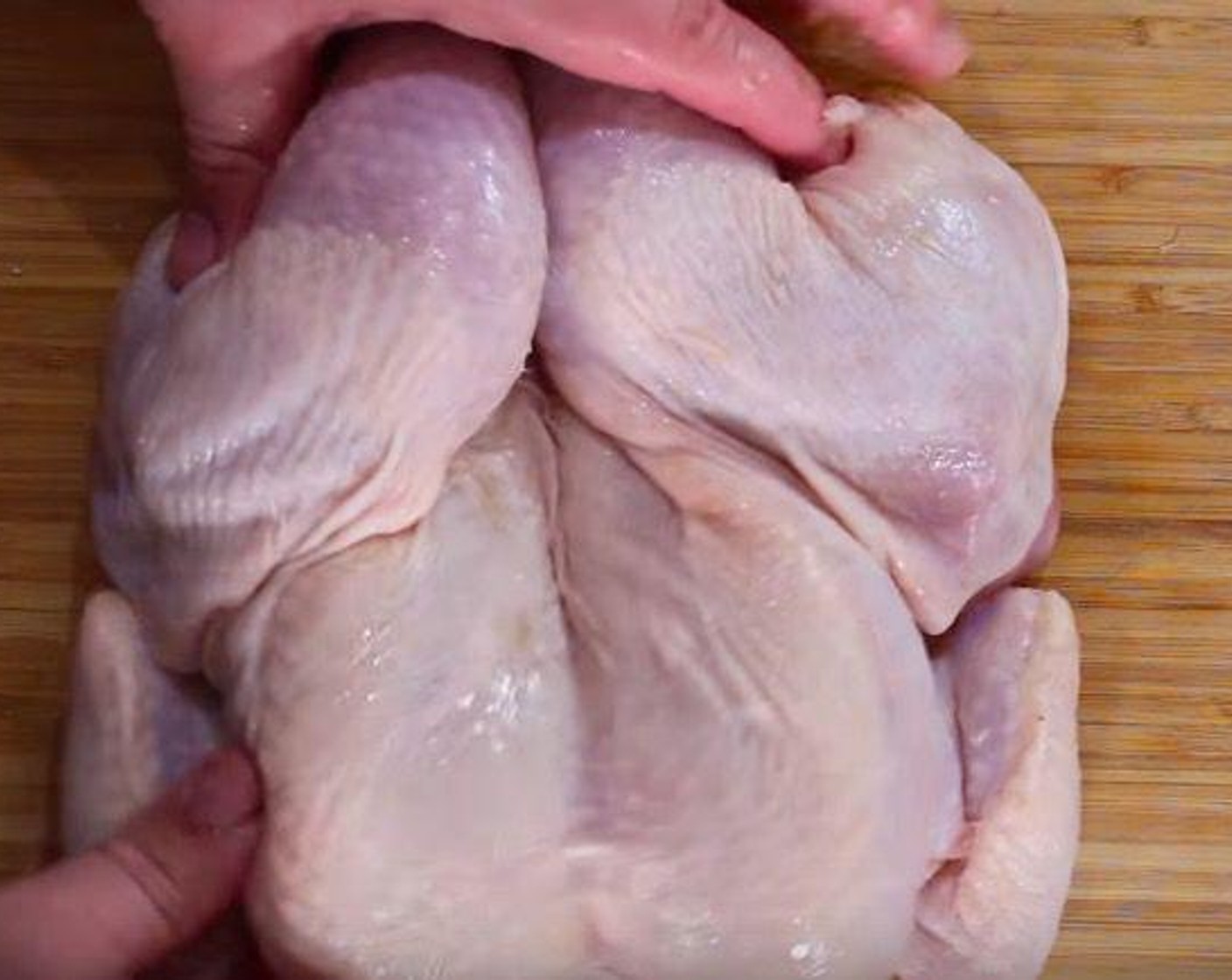 step 2 Carefully open up the chicken. Using a sharp knife, cut out the ribs and breastbone. Turn the chicken back over and set aside.