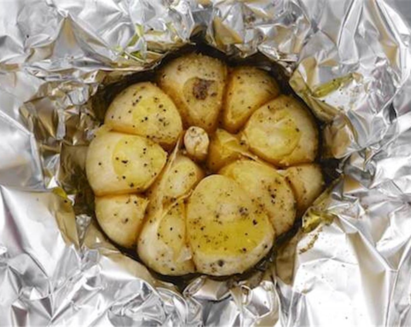step 4 Then wrap each half bulb in a piece of tinfoil and drizzle with some Olive Oil (1 Tbsp), Dried Mixed Herbs (1/2 tsp), Salt (to taste) and Ground Black Pepper (to taste).