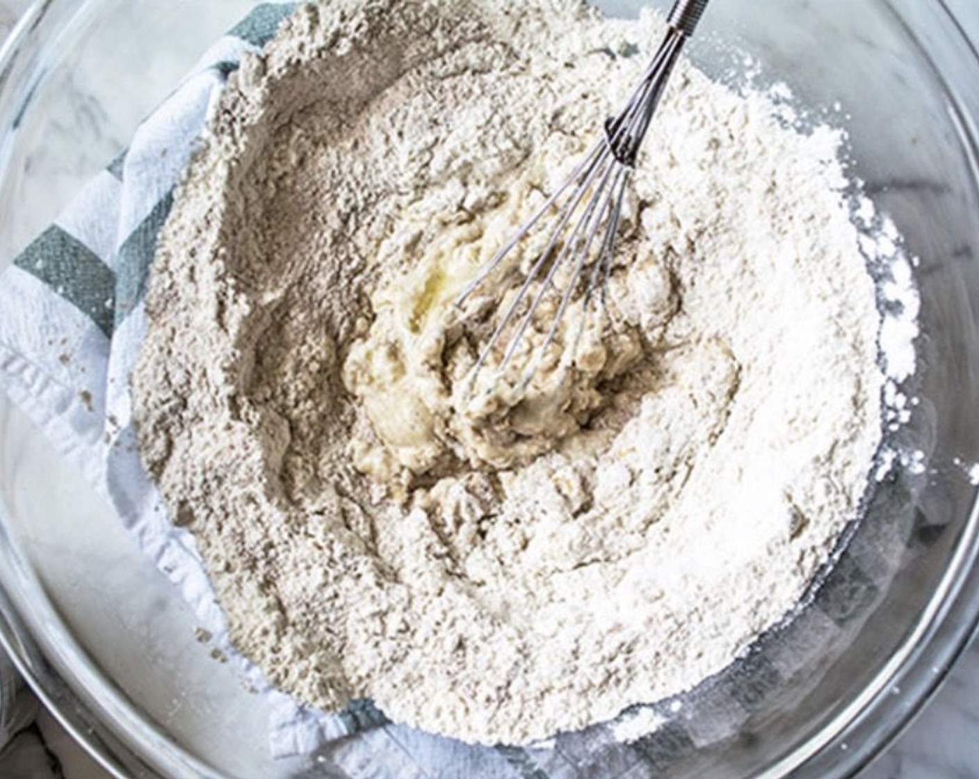 step 1 Add White Whole Wheat Flour (1 1/2 cups), All-Purpose Flour (1/2 cup), Nonfat Plain Greek Yogurt (3 Tbsp), {@10:}, Olive Oil (1 Tbsp), 2% Reduced Fat Milk (1/4 cup), Granulated Sugar (1 tsp), Sea Salt (1/2 tsp), McCormick® Garlic Powder (1/4 tsp), Baking Powder (1/2 tsp), and Baking Soda (1/2 tsp) to a large bowl.