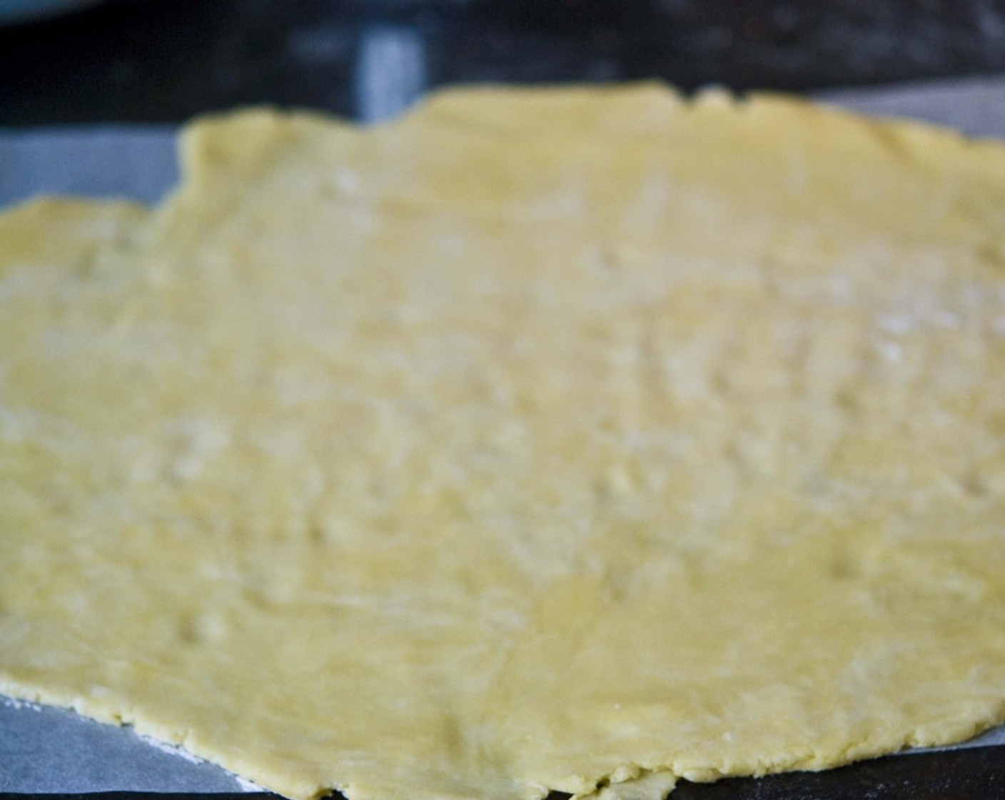 step 5 Place a baking sheet onto the counter, and sprinkle some flour on top. Transfer the dough to the baking sheet, add some flour on top, and roll out the dough.