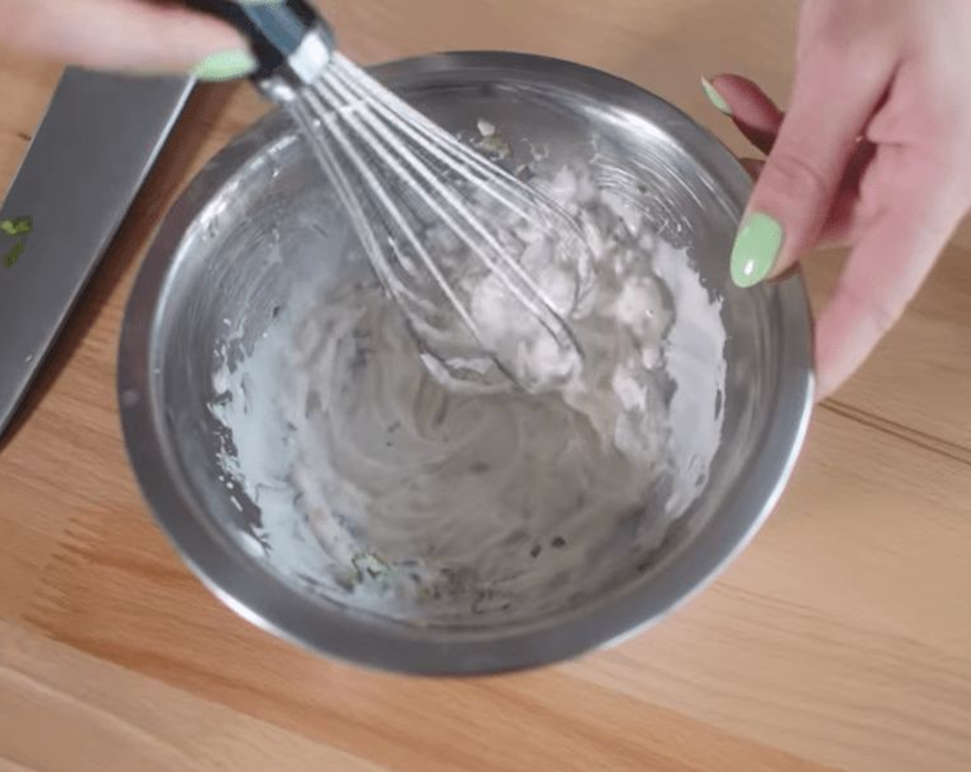 step 1 To make this Mexican corn salad, simply mix together Vegan Sour Cream (1/3 cup), Garlic (1 clove), and the juice of a Lime (1) in a small bowl.