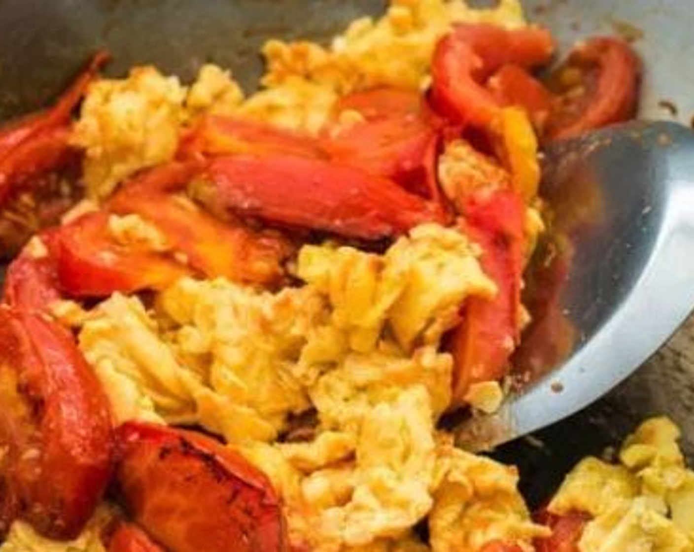 step 4 As soon as the tomatoes have softened, return the eggs to the wok. Stir to combine.