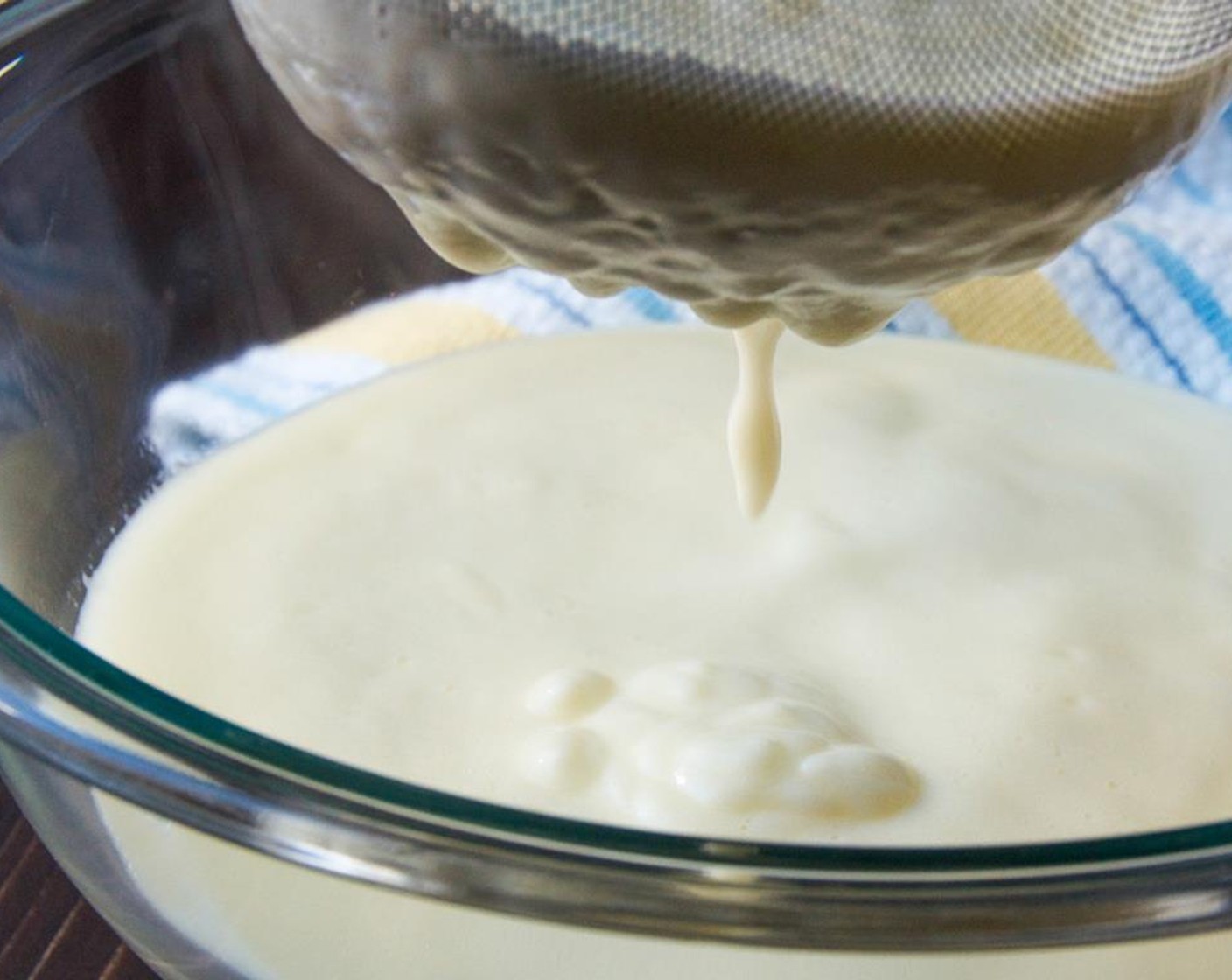 step 5 Set a fine-mesh strainer over a large bowl and strain the custard through the sieve to remove any egg solids. Allow the custard to cool for 10 minutes.