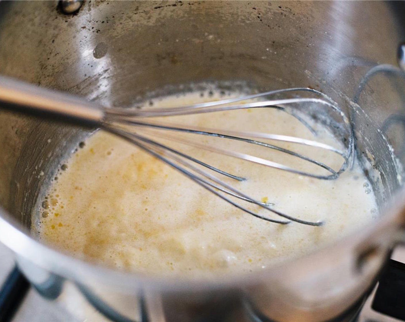 step 4 Slowly begin incorporating Milk (2 cups), a splash at a time, whisking continuously.